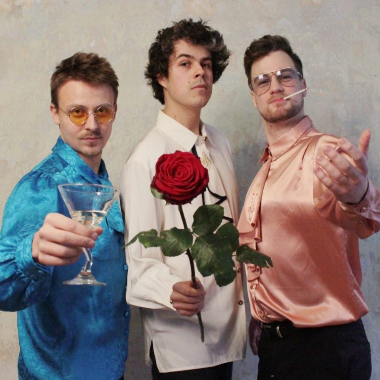 Trio Amore Vol.1 Cover Three musicians: first one holding champange second holding rose, third smokig cigarette (Nicolas Greiner, Johannes Bode, Lukas Growe)